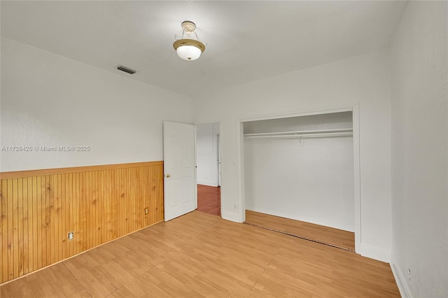 unfurnished bedroom featuring a closet and wood-type flooring