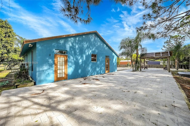 view of side of property with a patio area