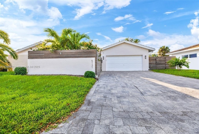 view of front of property with a garage and a front yard