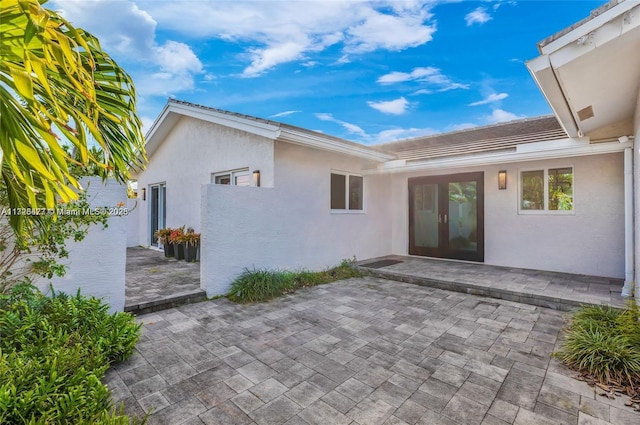 back of house with french doors and a patio