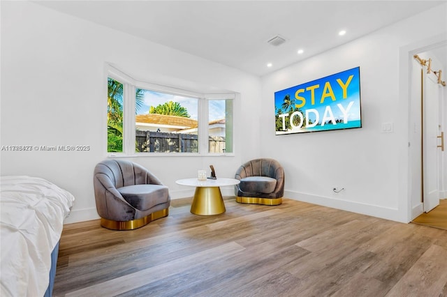 sitting room with hardwood / wood-style flooring