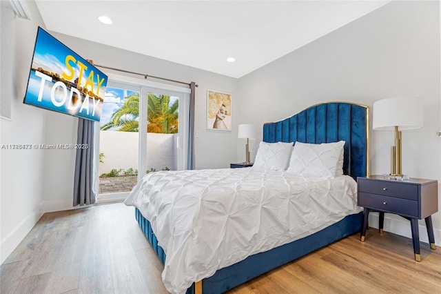 bedroom featuring access to exterior and wood-type flooring