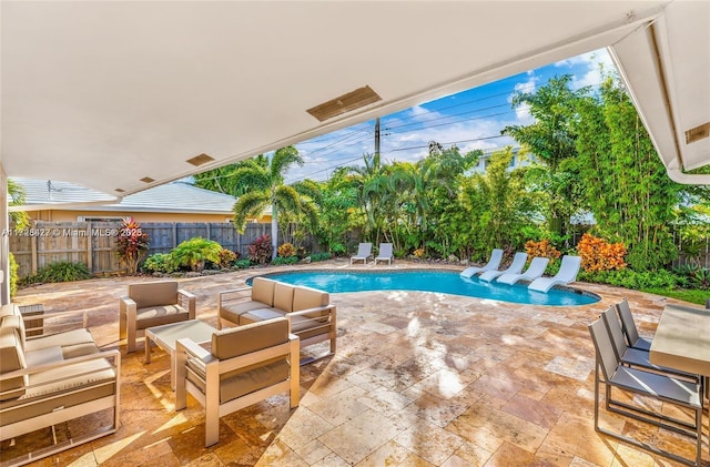 view of pool with a patio area and an outdoor living space