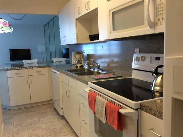 kitchen with white cabinets, backsplash, sink, and white appliances