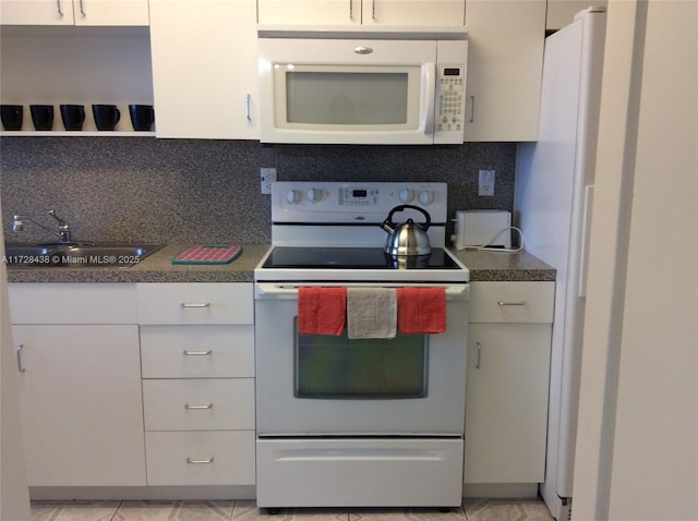 kitchen featuring backsplash, sink, white appliances, and white cabinetry