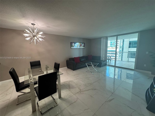 dining room featuring a notable chandelier, floor to ceiling windows, and a textured ceiling