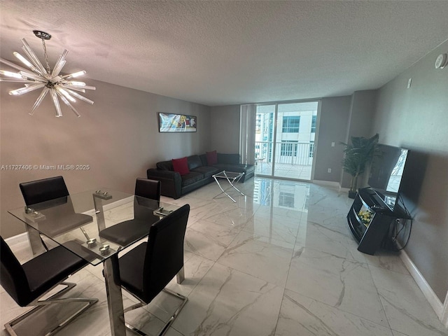 living room with floor to ceiling windows, a textured ceiling, and a notable chandelier