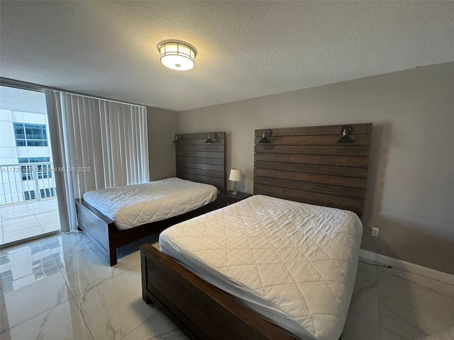 bedroom with a textured ceiling and access to outside