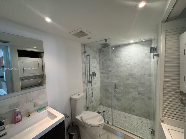 bathroom with an enclosed shower, vanity, decorative backsplash, and toilet