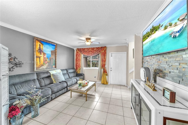 tiled living room with ceiling fan, ornamental molding, and a textured ceiling