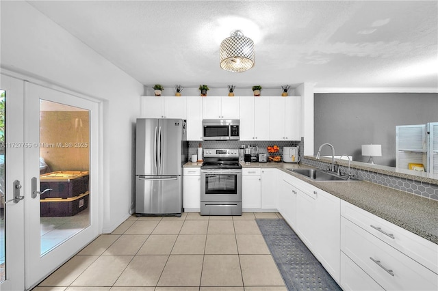 kitchen featuring white cabinetry, appliances with stainless steel finishes, sink, and tasteful backsplash