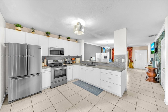 kitchen with a healthy amount of sunlight, sink, white cabinets, and appliances with stainless steel finishes