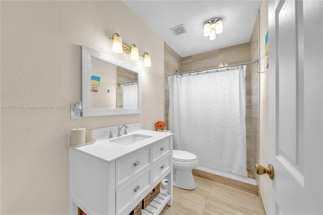 bathroom featuring vanity, toilet, curtained shower, and a textured ceiling