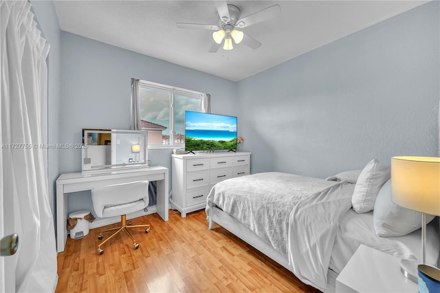 bedroom with light hardwood / wood-style flooring and ceiling fan