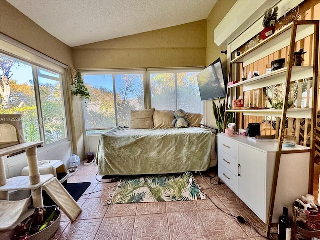 tiled bedroom with a textured ceiling and lofted ceiling