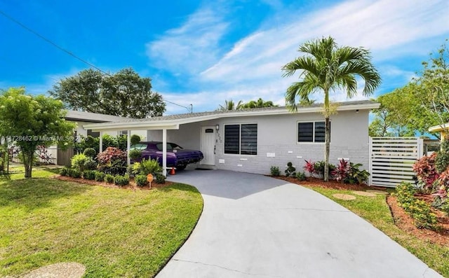 single story home with a front lawn and a carport