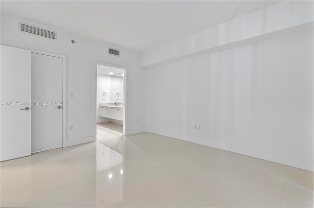 unfurnished room with light tile patterned floors