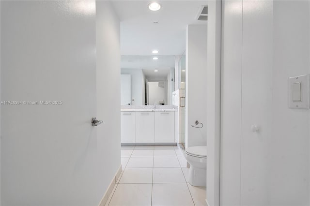 bathroom with toilet, tile patterned floors, an enclosed shower, and vanity