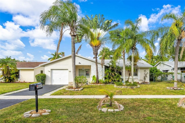 single story home featuring a front yard and a garage