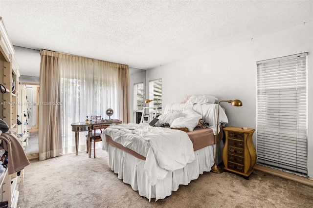 bedroom featuring a textured ceiling and carpet flooring