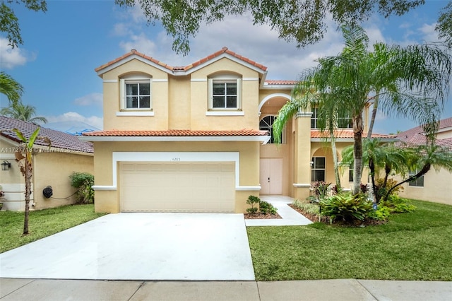 mediterranean / spanish house featuring a garage and a front lawn