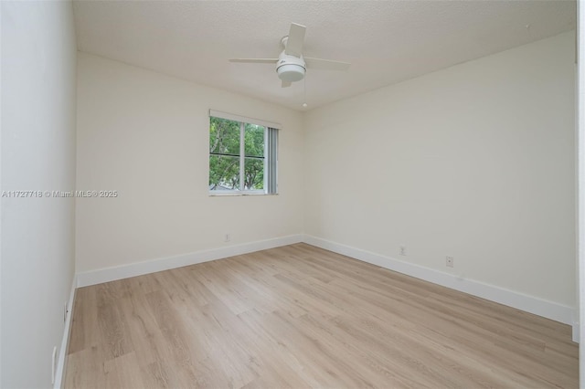 unfurnished room with ceiling fan, a textured ceiling, and light hardwood / wood-style flooring