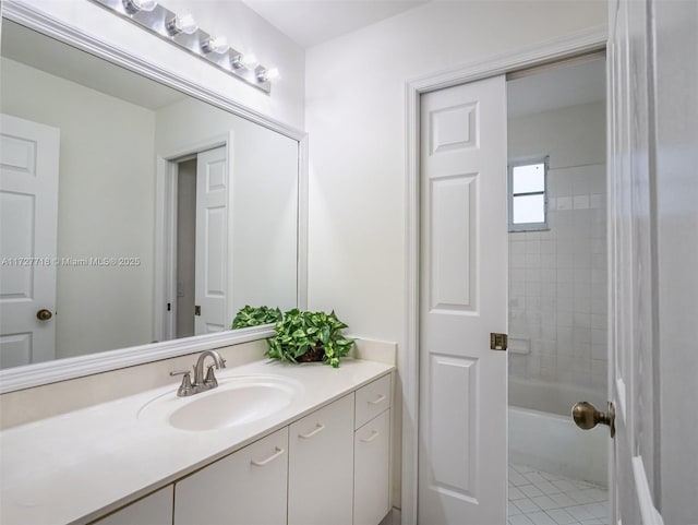 bathroom featuring tile patterned floors, vanity, and tiled shower / bath