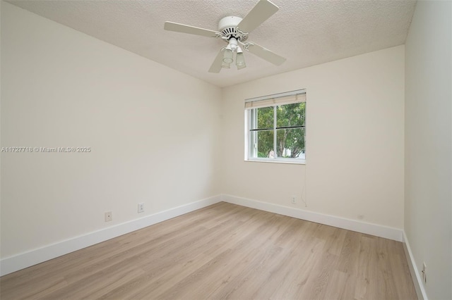 spare room with ceiling fan, a textured ceiling, and light wood-type flooring