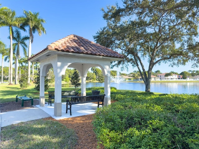 view of community featuring a water view and a lawn