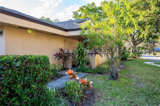 view of home's exterior with a yard