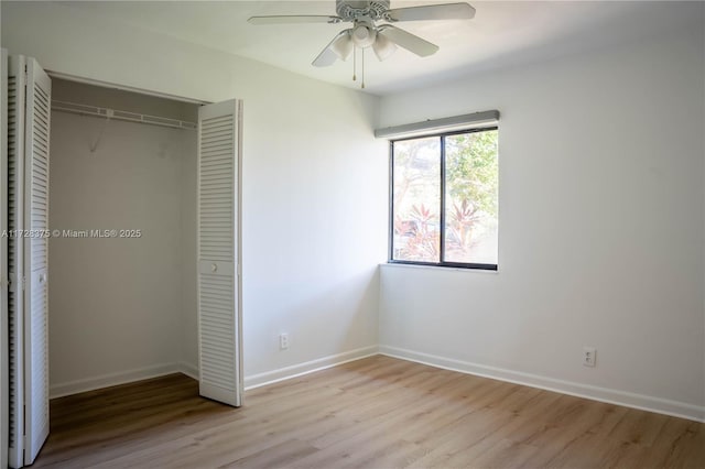 unfurnished bedroom with ceiling fan, light hardwood / wood-style flooring, and a closet