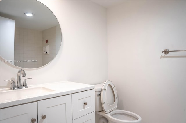 bathroom with toilet and vanity