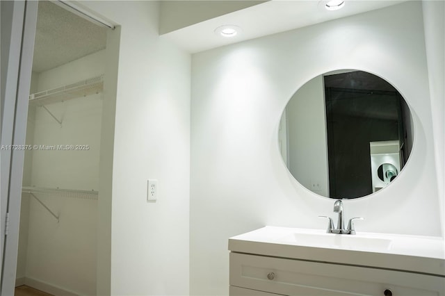 bathroom with vanity and washer / dryer