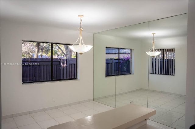 unfurnished dining area with light tile patterned floors