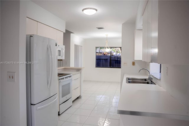 kitchen featuring white cabinets, sink, and white appliances