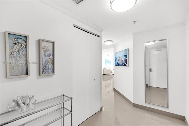 hallway with light tile patterned floors and ornamental molding