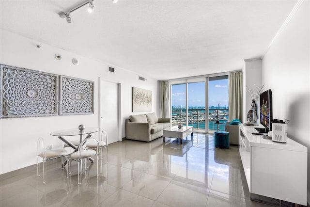 living room with a textured ceiling and floor to ceiling windows