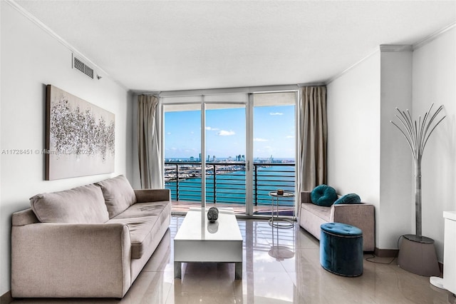 living room featuring a water view, a wall of windows, light tile patterned flooring, and ornamental molding