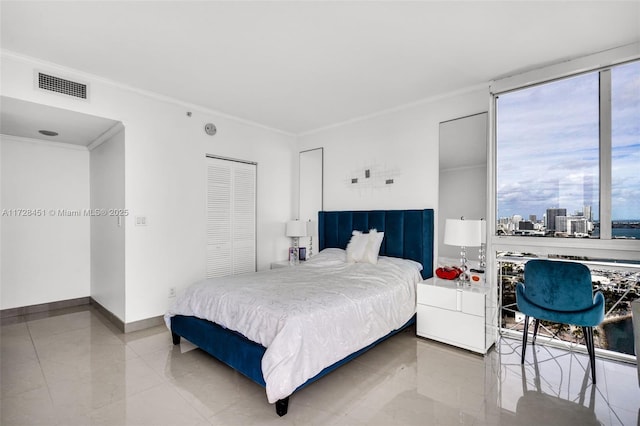 bedroom featuring a closet and crown molding