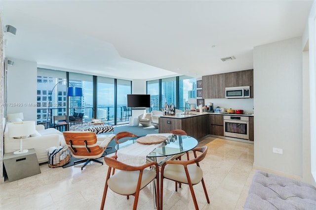 dining room featuring sink and floor to ceiling windows