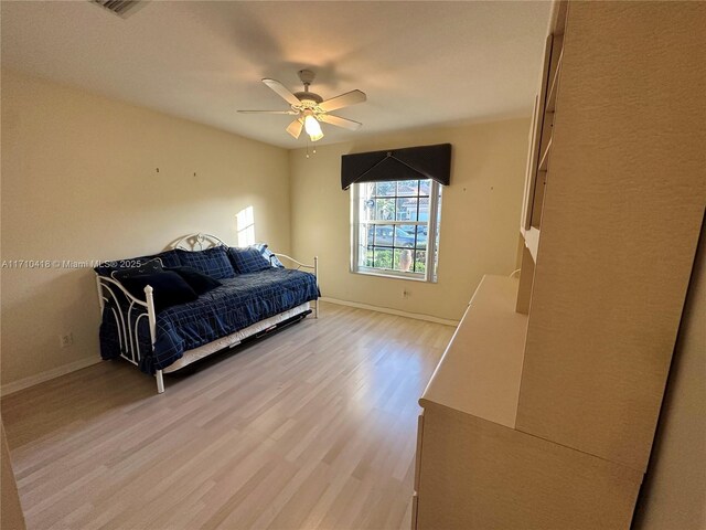 bedroom with ceiling fan and light hardwood / wood-style flooring