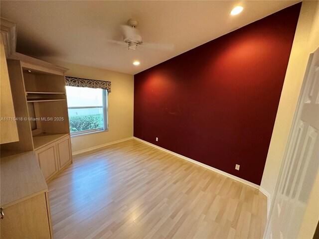 empty room featuring ceiling fan and light hardwood / wood-style floors