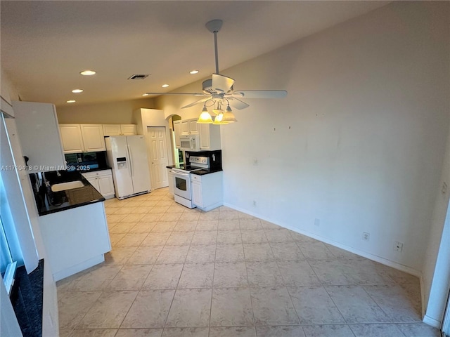 kitchen featuring vaulted ceiling, sink, white cabinets, and white appliances