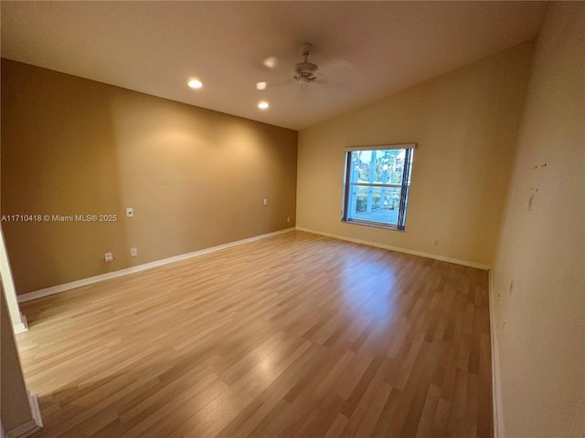 empty room with light wood-type flooring, ceiling fan, and lofted ceiling