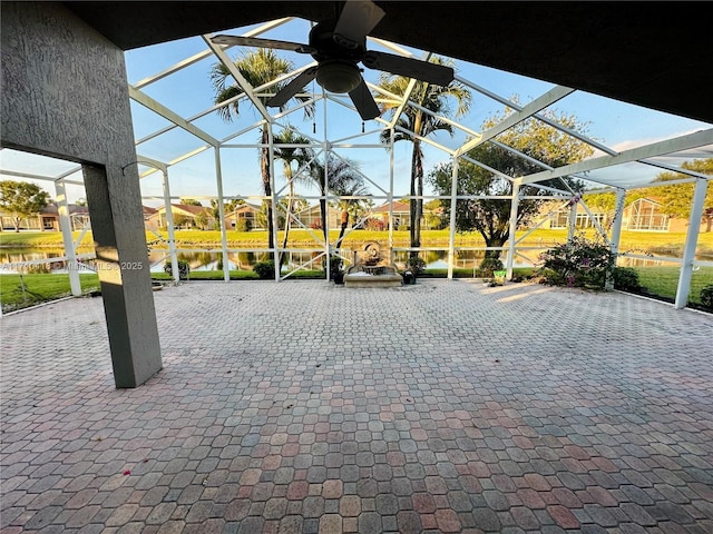 view of patio / terrace with a water view and glass enclosure