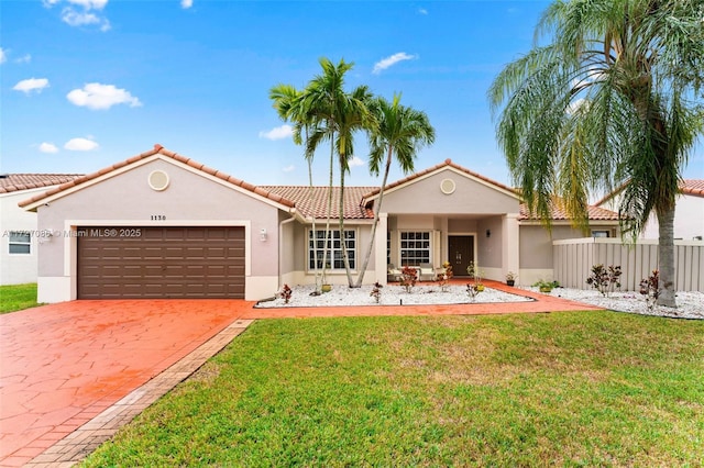 mediterranean / spanish house featuring a front lawn and a garage