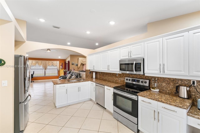 kitchen featuring ceiling fan, white cabinets, appliances with stainless steel finishes, and kitchen peninsula