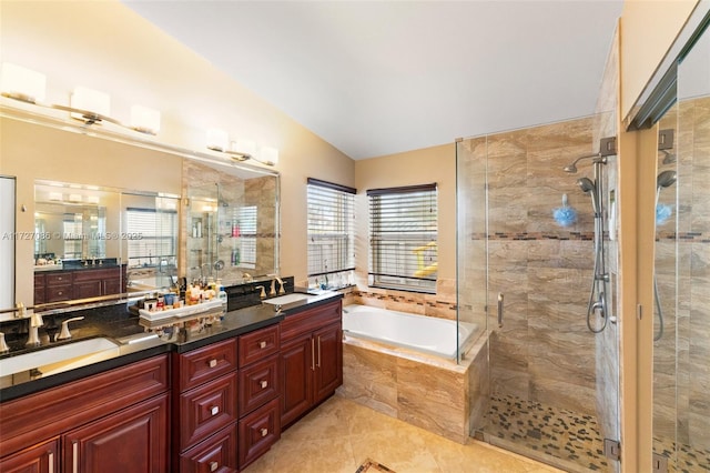 bathroom with tile patterned floors, vanity, lofted ceiling, and independent shower and bath