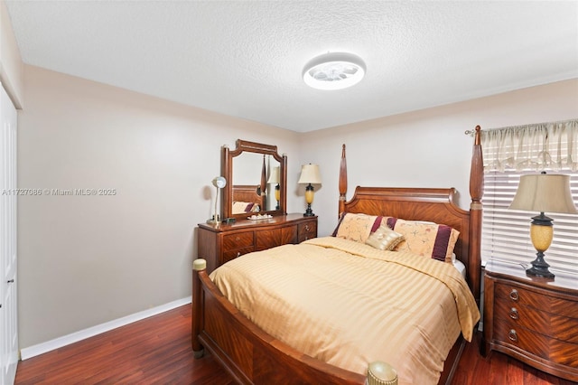 bedroom with dark hardwood / wood-style flooring and a textured ceiling