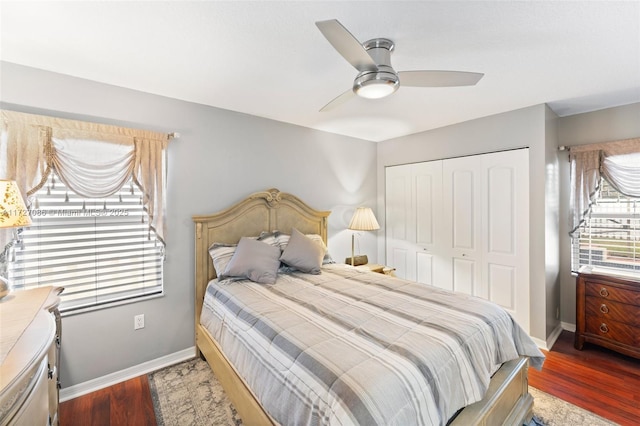 bedroom featuring ceiling fan, dark wood-type flooring, and a closet